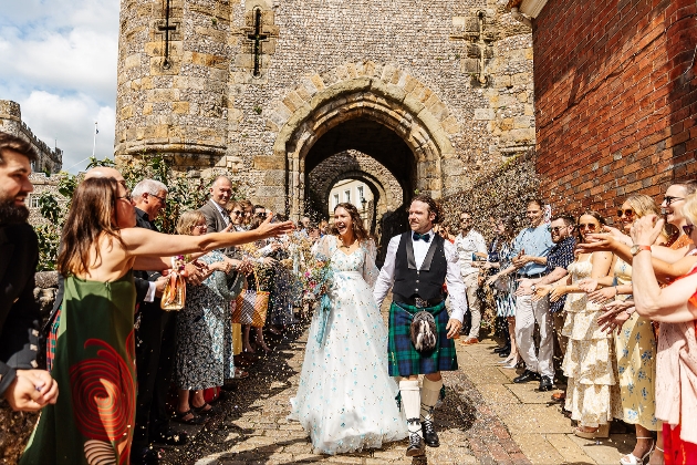 Bride and Groom leaving Lewes Castle ceremony in a hail of confetti