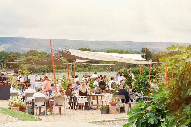 sail tent canopy with people seated enjoying Artelium Wine