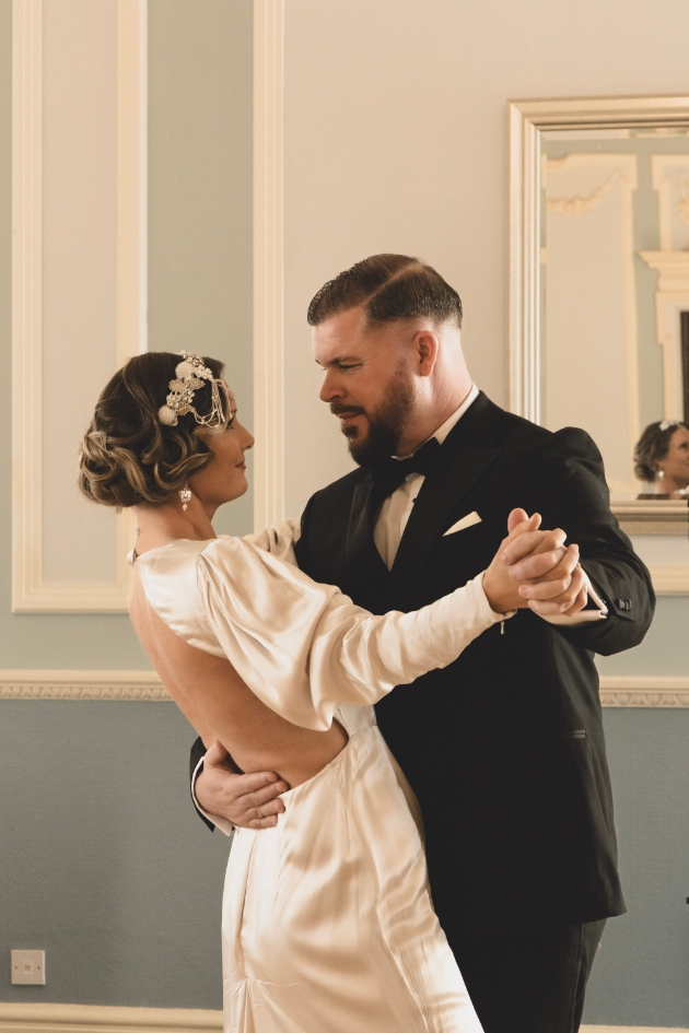 bride and groom wearing vintage 20s attire ballroom dancing