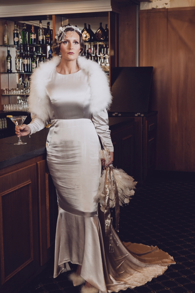bride wearing vintage 20s style satin fitted dress with faux fur wrap