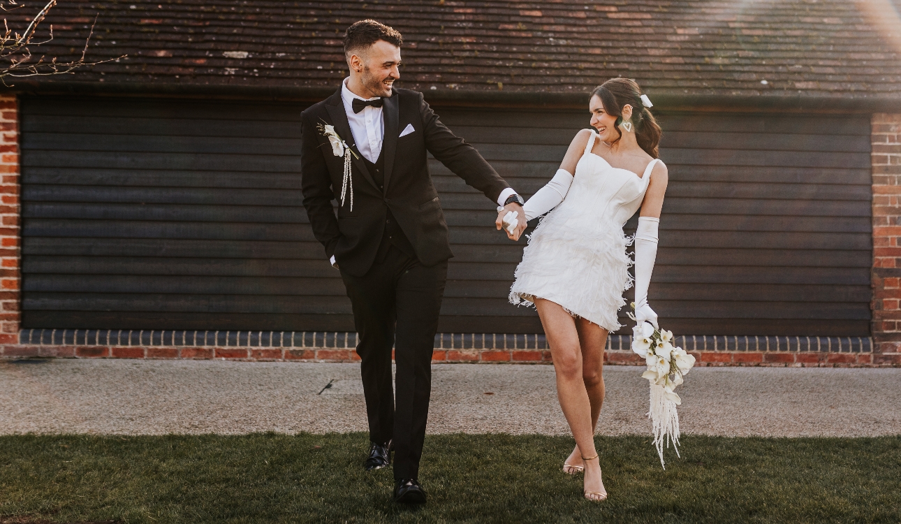 bride and groom holding hands and laughing