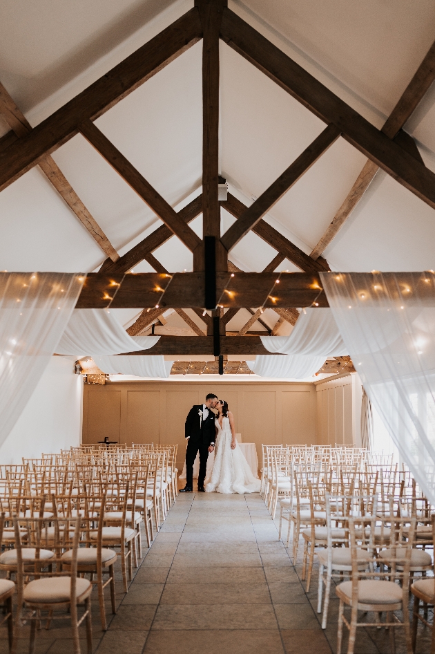 Bride and groom share a kiss in their ceremony space at Farbridge