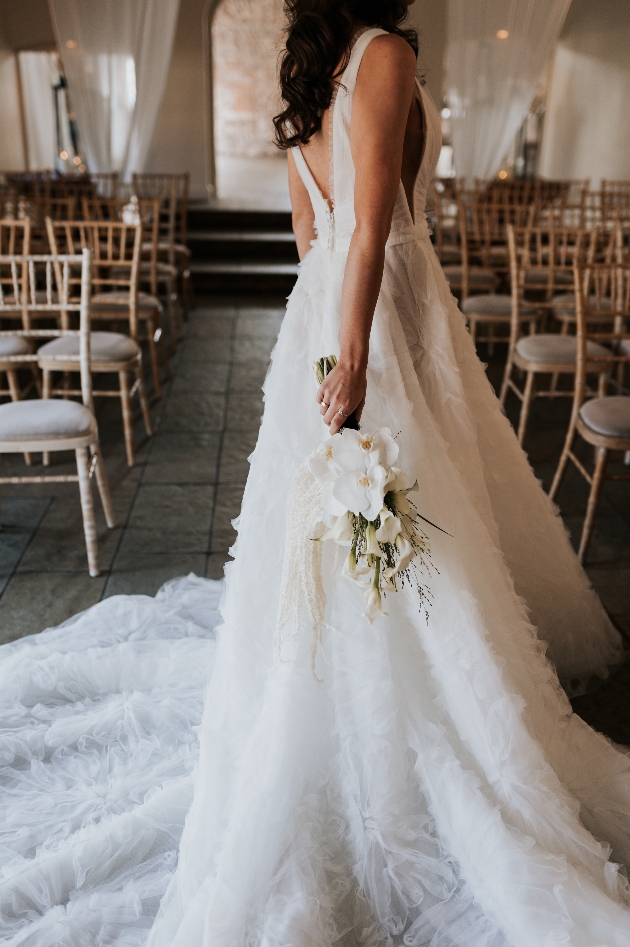 ruched wedding dress with long train. Orchid bridal bouquet