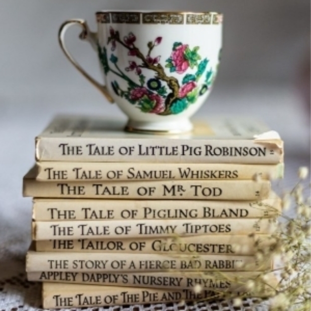 vintage tea cup stood on top of a stack of Beatrix Potter books
